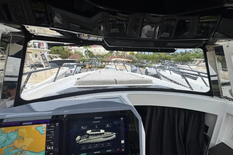 Slide: The Image of Interior view of a 2026 Navan C30 boat with navigation screens and marina in background. - 15