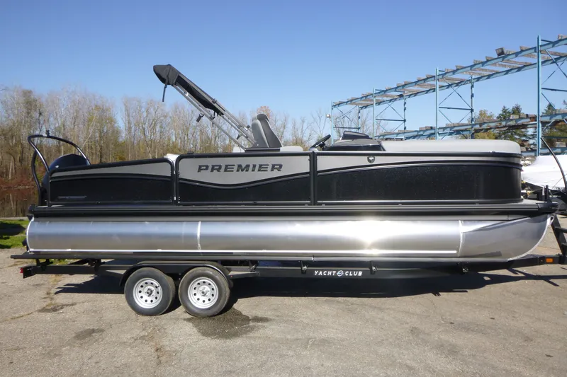 The Image of 2027 Premier 230 Sunsation RS - CL pontoon boat on trailer, parked outdoors. - 0