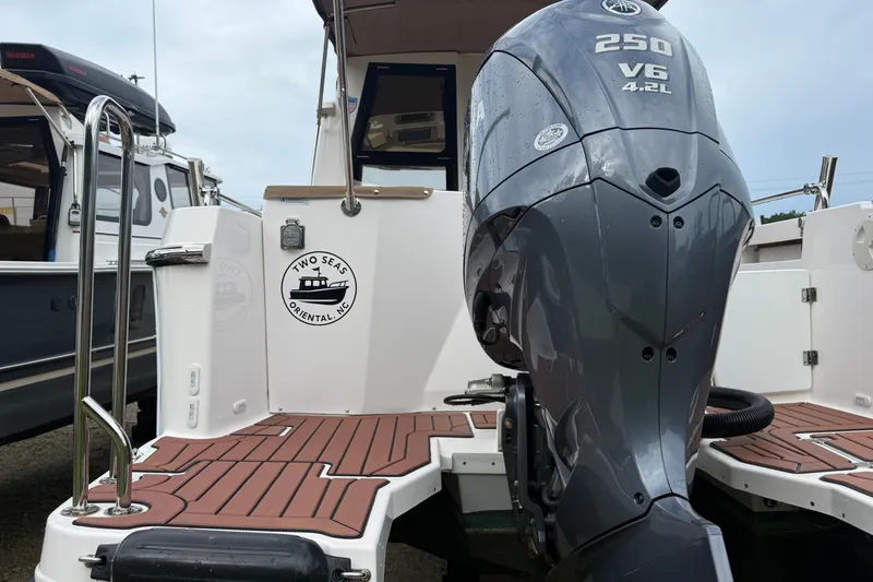 Slide: The Image of 2025 Ranger Tugs R-25 boat with Yamaha 250 V6 engine, docked at marina. - 5