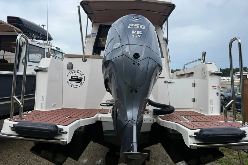 Slide: The Image of 2025 Ranger Tugs R-25 boat with Yamaha 250 V6 outboard motor, docked at marina. - 6