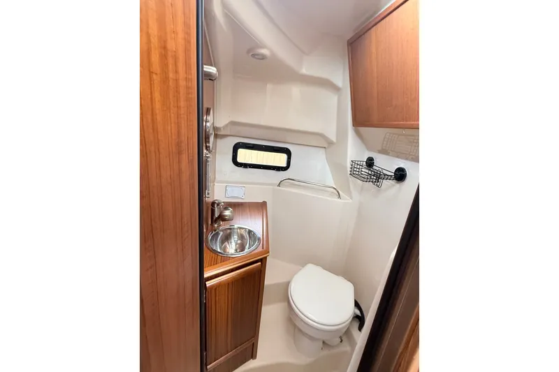 Slide: The Image of Compact bathroom in 2025 Ranger Tugs R-25 boat with sink and toilet. - 19