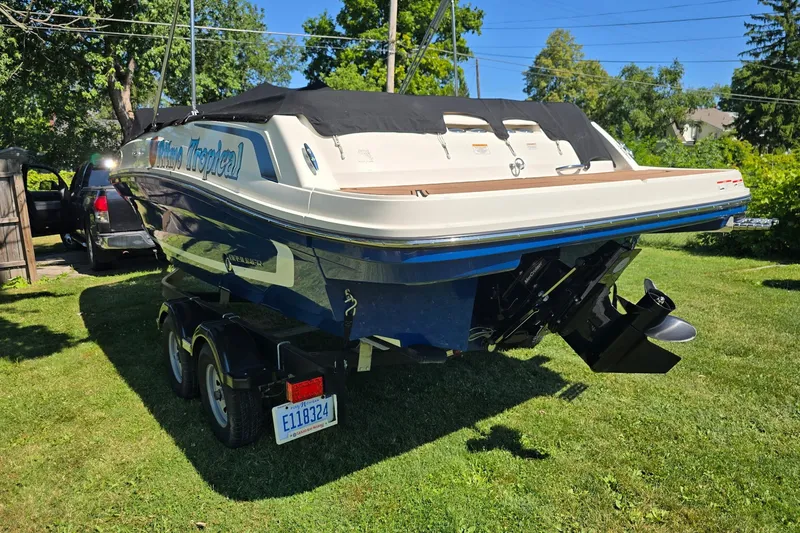 Slide: The Image of 2019 Bayliner VR6 Bowrider I/O on trailer, parked on grass, with cover. - 3