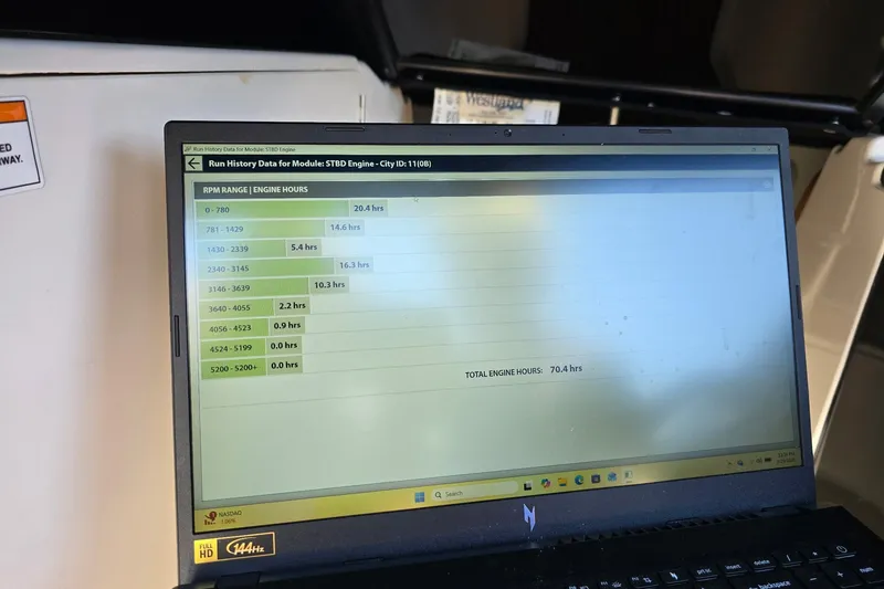 Slide: The Image of Laptop displaying engine run history data for 2019 Bayliner VR6 Bowrider I/O. - 21