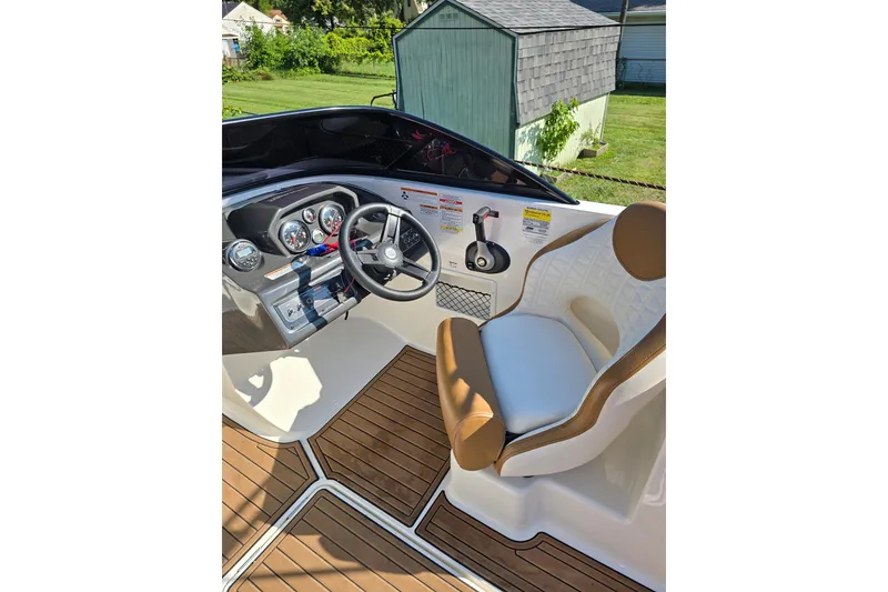 Slide: The Image of 2019 Bayliner VR6 Bowrider I/O cockpit with steering wheel and cushioned seat. - 12