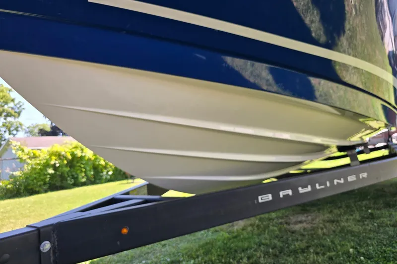 Slide: The Image of 2019 Bayliner VR6 Bowrider I/O on trailer, showcasing sleek hull design. - 2