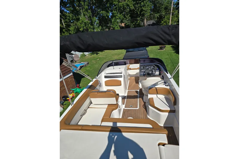Slide: The Image of 2019 Bayliner VR6 Bowrider I/O interior with tan seating and wood accents. - 5