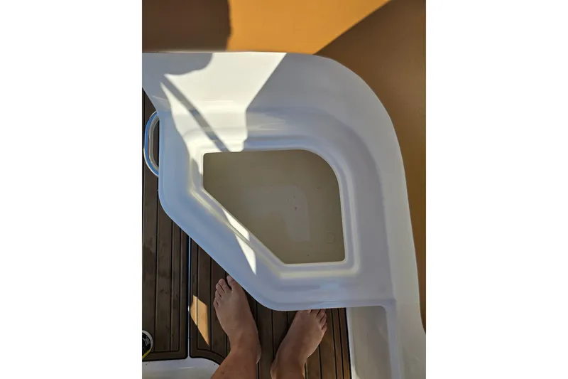 Slide: The Image of 2019 Bayliner VR6 Bowrider I/O deck with feet visible, showcasing boat's interior design. - 15