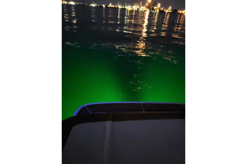 Slide: The Image of 2019 Bayliner VR6 Bowrider I/O at night with green underwater lights. - 25