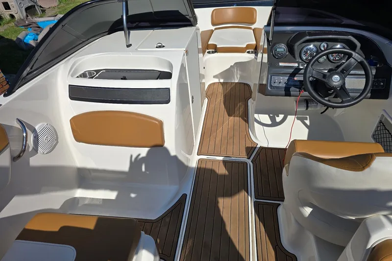 Slide: The Image of 2019 Bayliner VR6 Bowrider I/O interior with tan seating and wood-style flooring. - 7