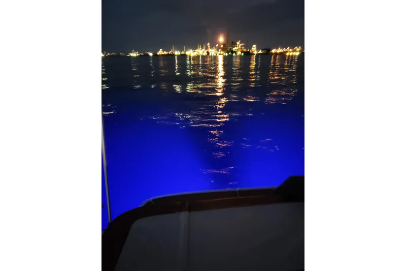 Slide: The Image of 2019 Bayliner VR6 Bowrider I/O on water at night with city lights reflecting. - 27