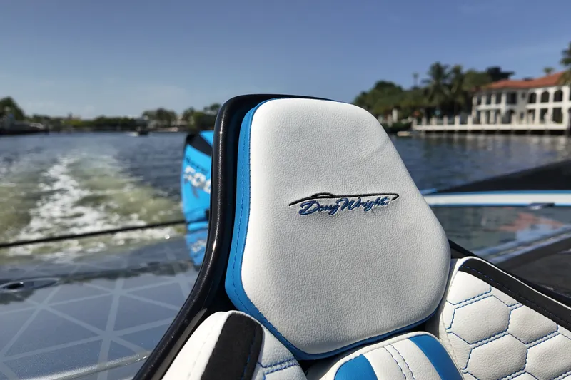 Slide: The Image of Luxury Doug Wright 420 boat seat with logo, cruising on a sunny waterway, 2027 model. - 17