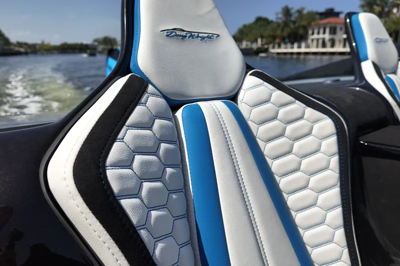 Slide: The Image of Luxury boat seat with hexagonal pattern, Doug Wright 420, 2027 model, on a scenic waterway. - 16