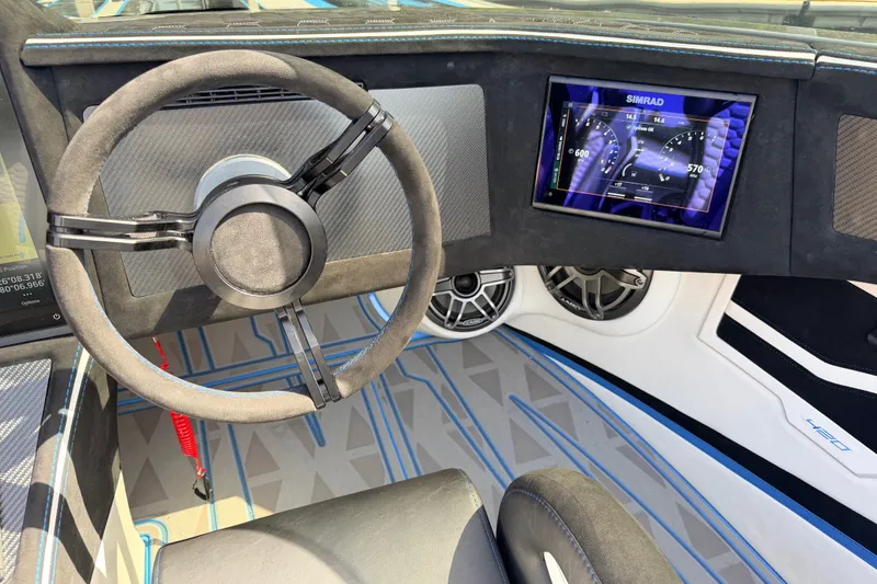 Slide: The Image of Interior of Doug Wright 420 (2027) boat with steering wheel and digital display. - 25