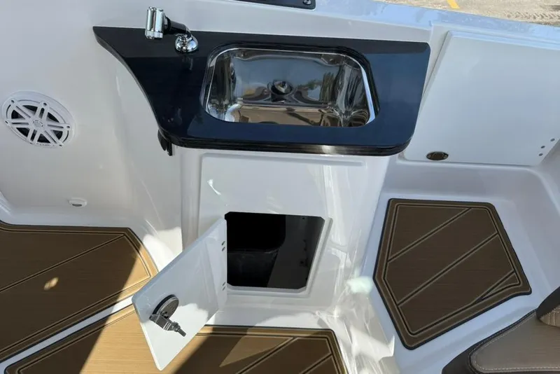 Slide: The Image of 2026 Monterey Elite 27 SD boat interior with sink and storage compartment. - 15