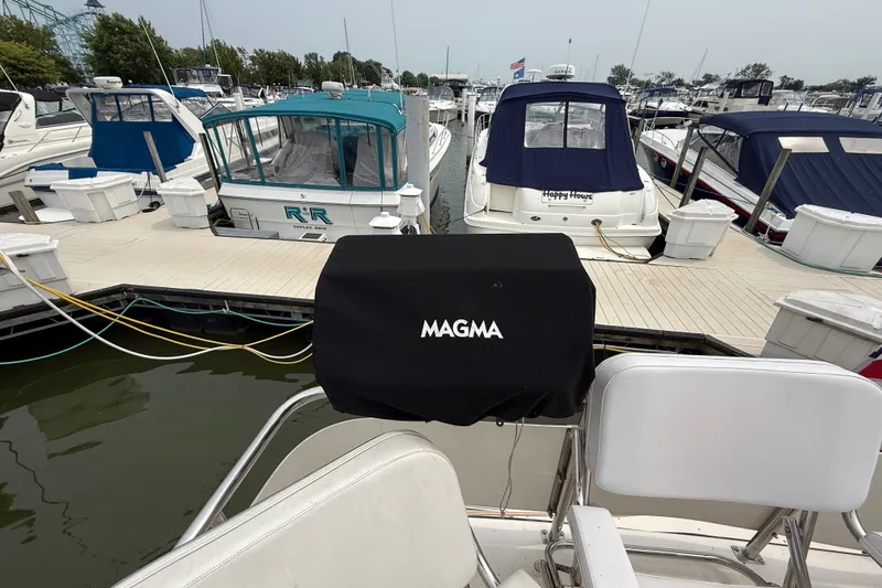 Slide: The Image of 1987 Sea Ray 410 Aft Cabin docked at marina with covered grill. - 8