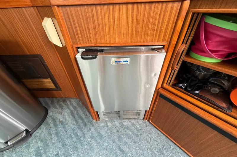 Slide: The Image of 1987 Sea Ray 410 Aft Cabin interior with Raritan stainless steel refrigerator. - 13