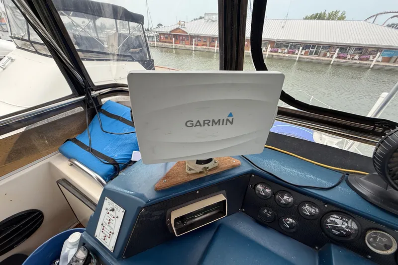 Slide: The Image of Cockpit of 1987 Sea Ray 410 Aft Cabin with Garmin navigation system. - 48
