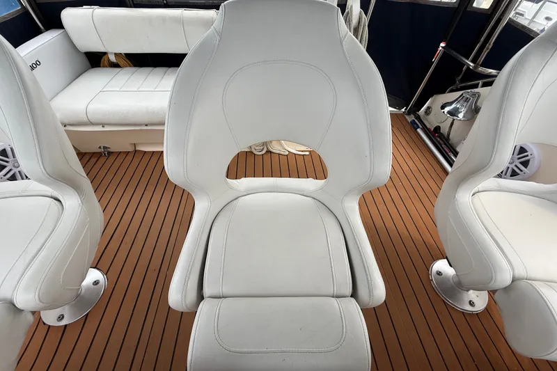Slide: The Image of Interior of 1987 Sea Ray 410 Aft Cabin with white seating and wood flooring. - 51