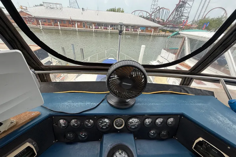 Slide: The Image of Helm of 1987 Sea Ray 410 Aft Cabin with marina and amusement park view. - 44