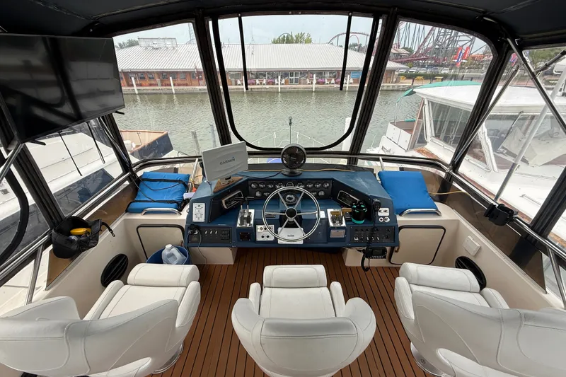 Slide: The Image of 1987 Sea Ray 410 Aft Cabin helm with modern navigation equipment and comfortable seating. - 41