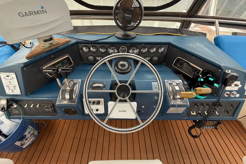 Slide: The Image of Helm of 1987 Sea Ray 410 Aft Cabin with Garmin navigation system and classic controls. - 42