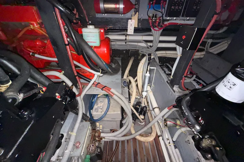 Slide: The Image of Engine room of a 1987 Sea Ray 410 Aft Cabin with visible wiring and components. - 37