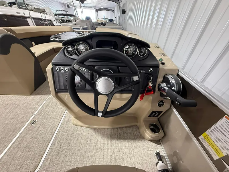 Slide: The Image of 2025 Berkshire 24CL CTS boat dashboard with steering wheel and controls in a showroom. - 6