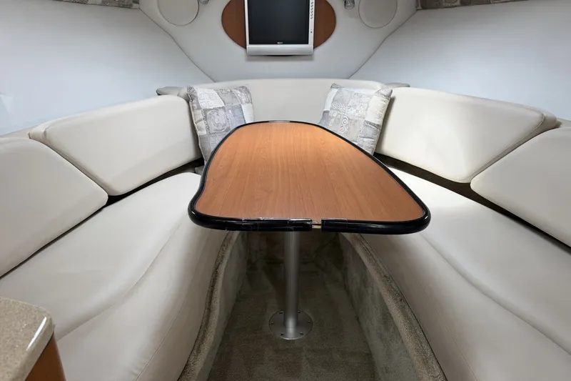 Slide: The Image of Interior of 2010 Crownline 280 CRX boat with cozy seating and wooden table. - 4