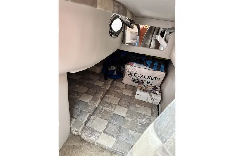 Slide: The Image of Interior cabin of 2010 Crownline 280 CRX with life jackets and patterned flooring. - 10