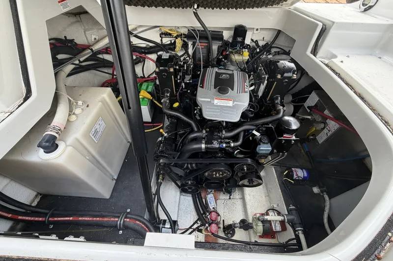 Slide: The Image of Engine compartment of a 2010 Crownline 280 CRX boat, showcasing detailed components. - 12