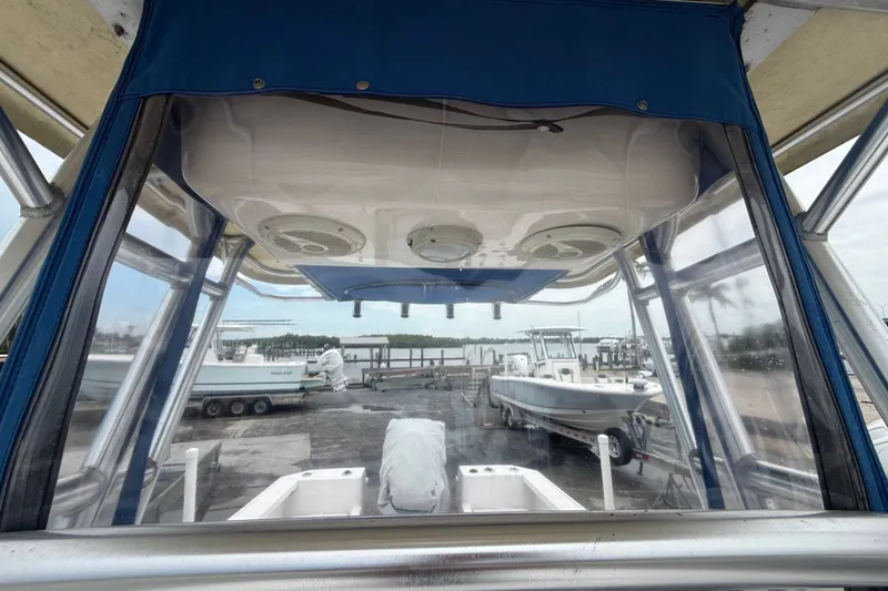 Slide: The Image of 2003 Pro-Line 22 Sport boat interior view with marina background. - 18