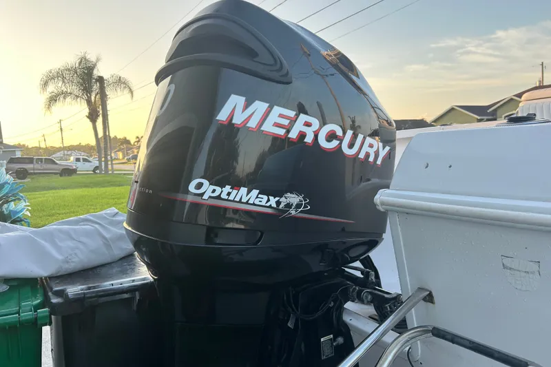 Slide: The Image of Mercury OptiMax engine on a 2003 Pro-Line 22 Sport boat at sunset. - 19