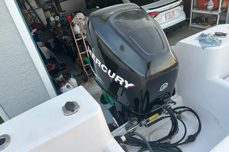 Slide: The Image of 2003 Pro-Line 22 Sport boat with Mercury outboard motor in a garage setting. - 20