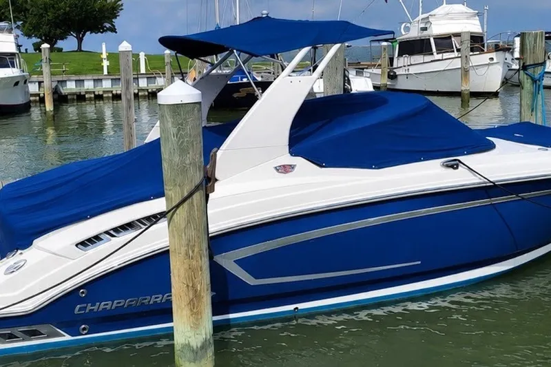 The Image of 2016 Chaparral 257 SSX SE boat docked, featuring blue covers and sleek design. - 0