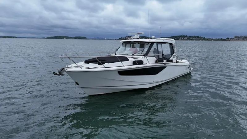 Slide: The Image of 2021 Boston Whaler 405 Conquest boat on calm water under cloudy skies. - 6