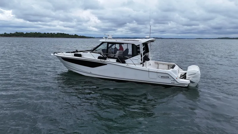 Slide: The Image of 2021 Boston Whaler 405 Conquest boat on calm water under cloudy sky. - 5