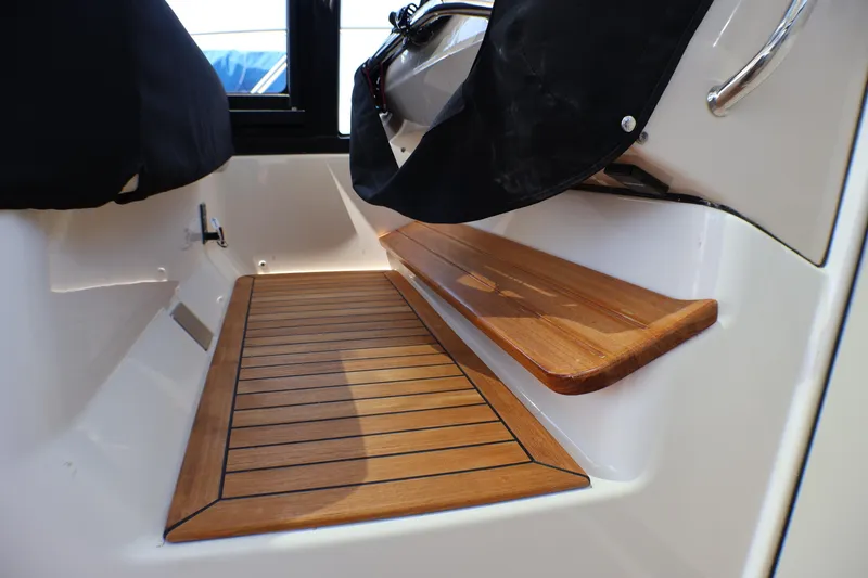 Slide: The Image of Teak flooring and seating detail on 2021 Boston Whaler 405 Conquest boat. - 41