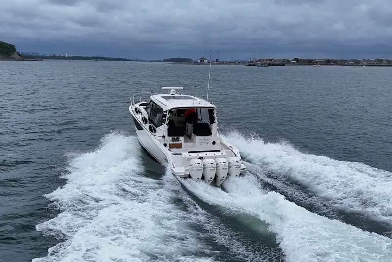 Slide: The Image of 2021 Boston Whaler 405 Conquest cruising on open water, rear view. - 15