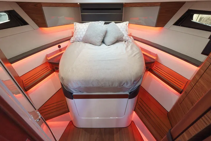 Slide: The Image of Luxurious cabin interior of 2021 Boston Whaler 405 Conquest with ambient lighting and cozy bedding. - 34