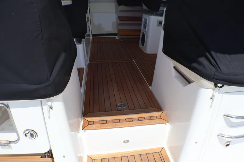 Slide: The Image of 2021 Boston Whaler 405 Conquest interior with teak flooring and black seating covers. - 37