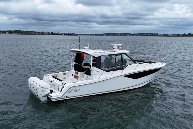 Slide: The Image of 2021 Boston Whaler 405 Conquest boat on calm water under cloudy skies. - 8