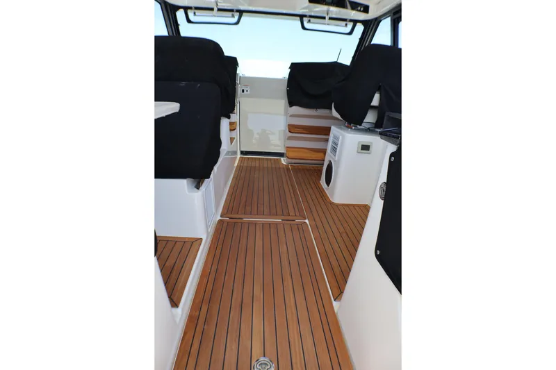 Slide: The Image of Interior of 2021 Boston Whaler 405 Conquest with teak flooring and covered seating. - 1