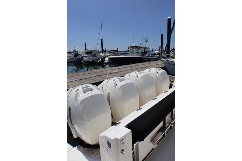 Slide: The Image of Boston Whaler 405 Conquest 2021 with four powerful outboard engines docked at marina. - 35