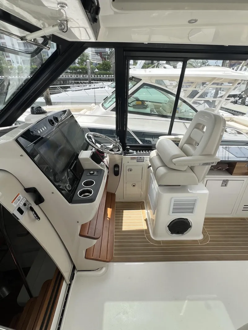 Slide: The Image of 2021 Boston Whaler 405 Conquest helm with modern controls and comfortable seating. - 29