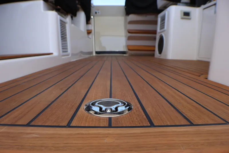 Slide: The Image of Teak deck of 2021 Boston Whaler 405 Conquest boat, featuring sleek design elements. - 36