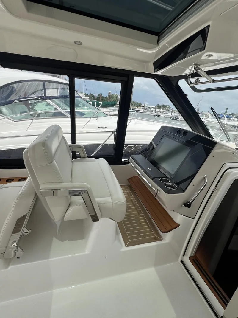 Slide: The Image of 2021 Boston Whaler 405 Conquest helm with modern controls and comfortable seating. - 27