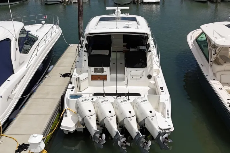 Slide: The Image of 2021 Boston Whaler 405 Conquest docked with four powerful outboard engines. - 22