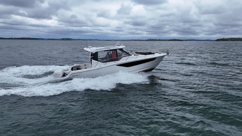 Slide: The Image of Boston Whaler 405 Conquest 2021 cruising on open water under cloudy skies. - 11