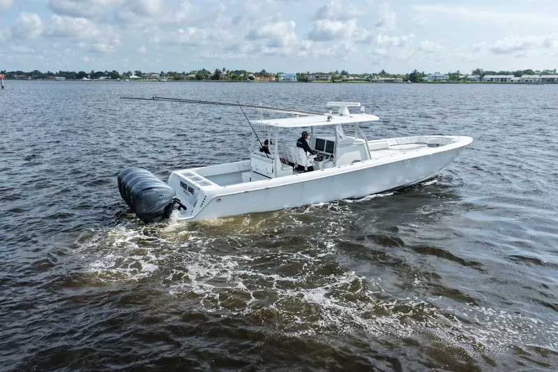 Slide: The Image of 2023 Contender 44 ST boat cruising on open water with triple Yamaha engines. - 22