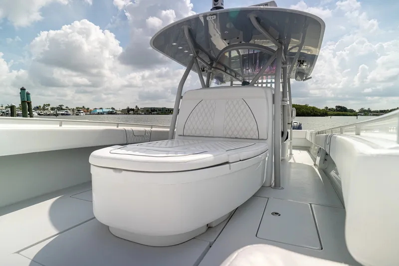 Slide: The Image of 2023 Contender 44 ST boat with sleek seating and canopy on a sunny day. - 18